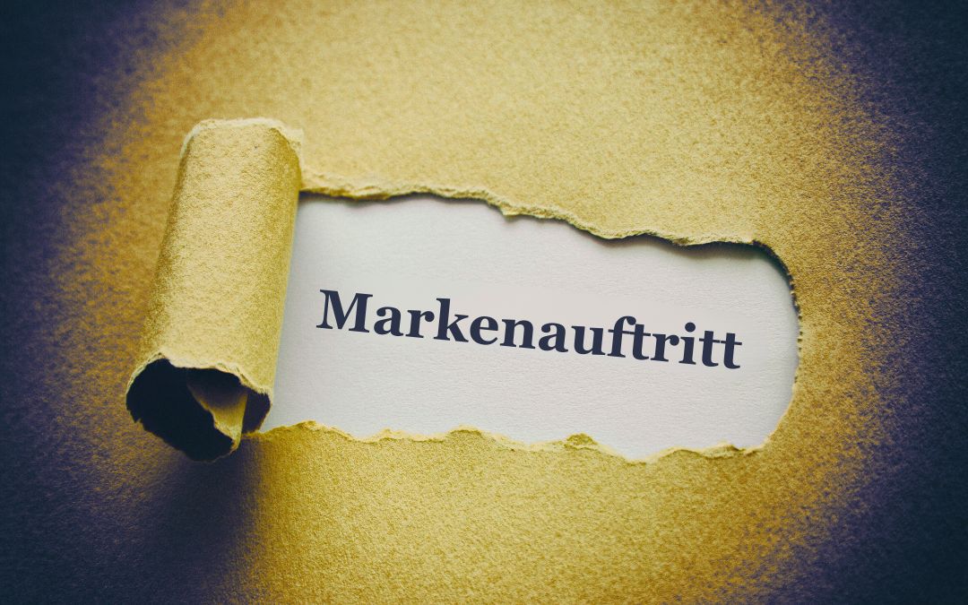Ein aufgerissenes Stück gelbes Papier, unter dem das Wort "Markenauftritt" erscheint.